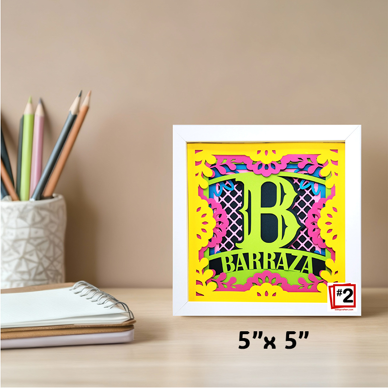 Colorful decorative item with 'BARRAZA' text on a desk with stationery items.