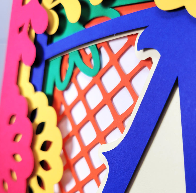 Colorful cut-out letters and shapes on a white background