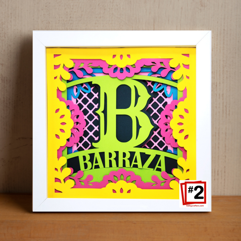 Decorative wall art with colorful letter 'B' and 'BARRAZA' text on a yellow background.