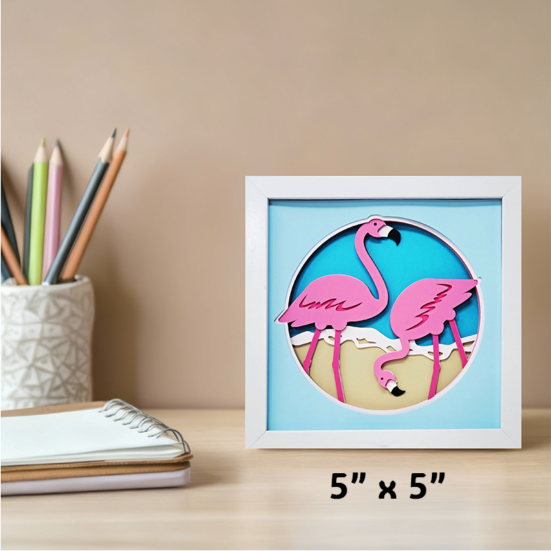 Framed artwork of two pink flamingos on a blue background with '5" x 5"' text.