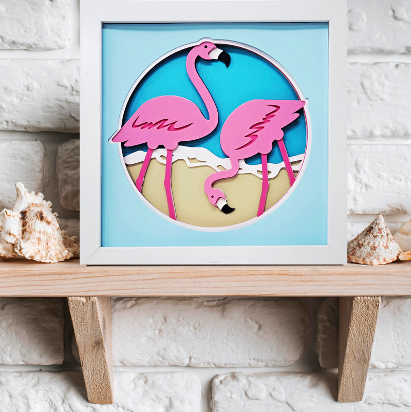 Framed artwork of pink flamingos on a white brick wall background