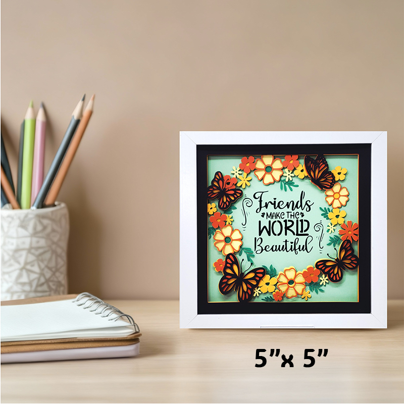 Framed artwork with butterflies and flowers on a desk with stationery items.