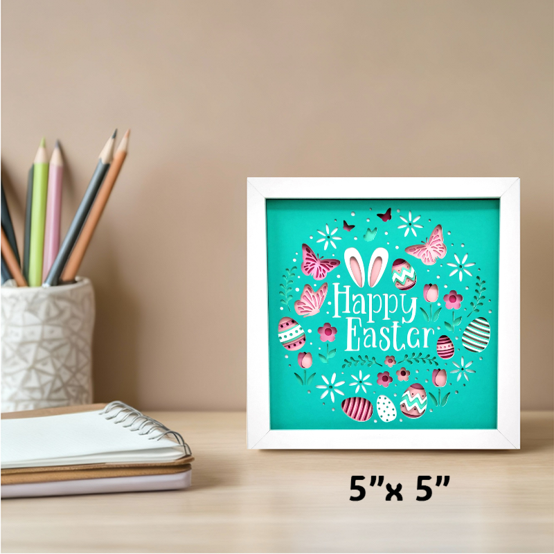 Framed 'Happy Easter' artwork on a desk with stationery items.