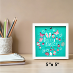 Framed 'Happy Easter' artwork on a desk with stationery items.