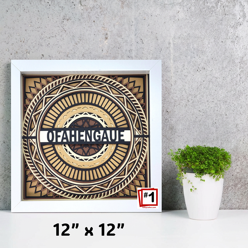 Decorative wall art with 'O'Hengale' design in a white frame, next to a potted plant on a gray surface.