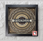 Decorative wall art with geometric design and 'OFAHENGAU' text on a textured white wall.