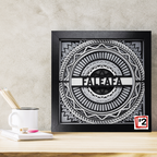 Decorative wall art with 'FALEAFA' design on a wooden surface.