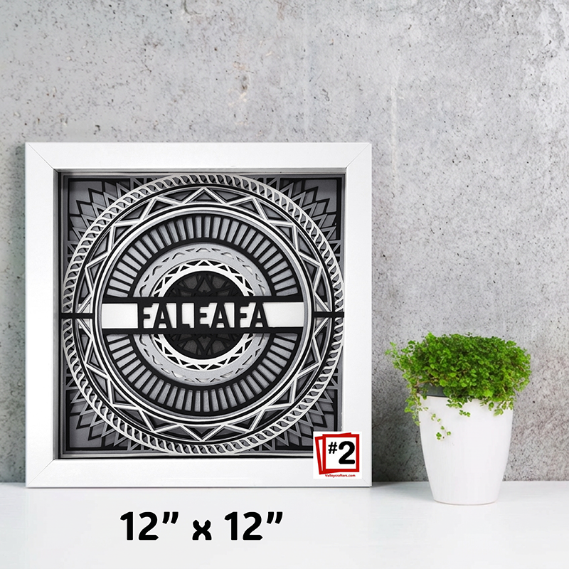 Framed artwork with geometric design and 'FALEAFA' branding on a gray wall with a plant.