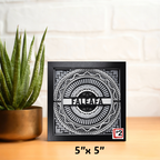 Decorative wall art with 'Faleafa' design on a wooden surface with a plant in the background
