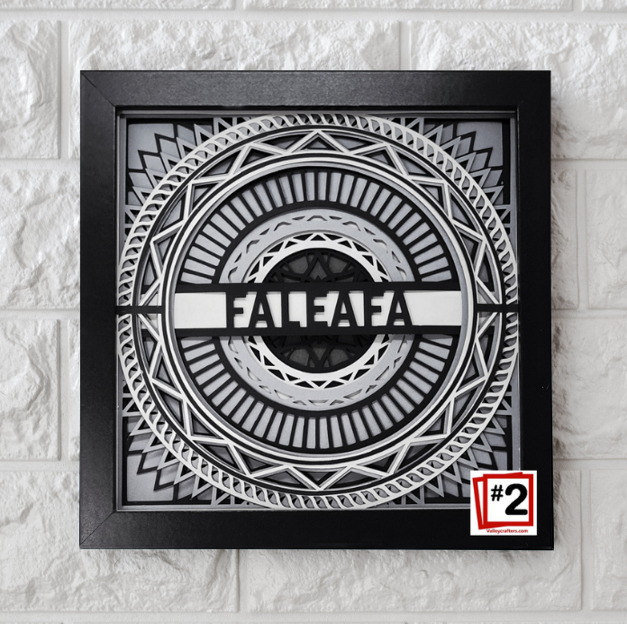 Decorative wall art with geometric design and 'FALEAFA' branding on a textured wall.