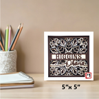 Decorative wall art with 'Higgins' and 'Ohana' text on a desk with stationery items.