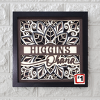 Decorative wall art with 'Higgins Ohana' text in a black frame on a textured white wall.