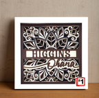 Decorative wall art with floral design and text on a wooden surface