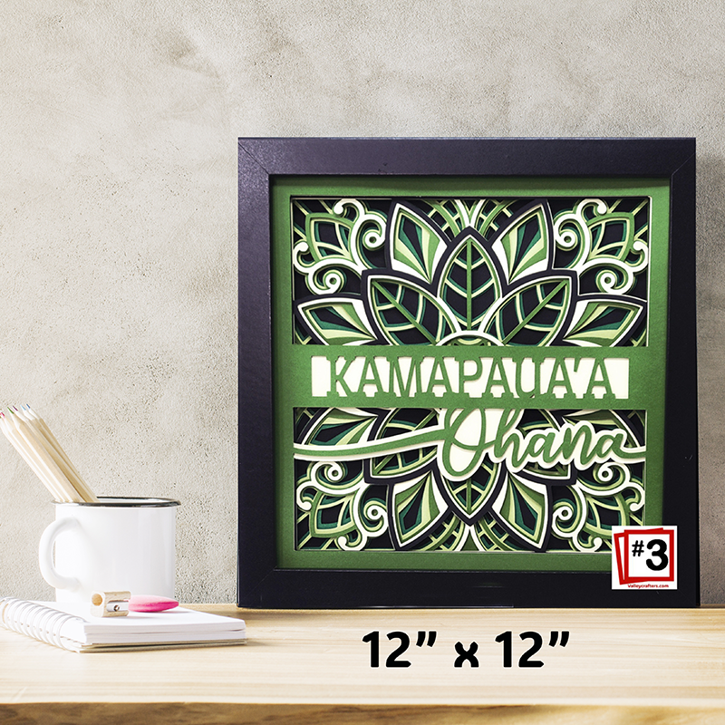 Decorative wall art with floral design and text on a wooden surface.