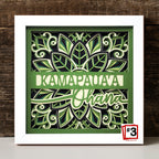 Decorative wall art with green leaf patterns and text on a wooden background