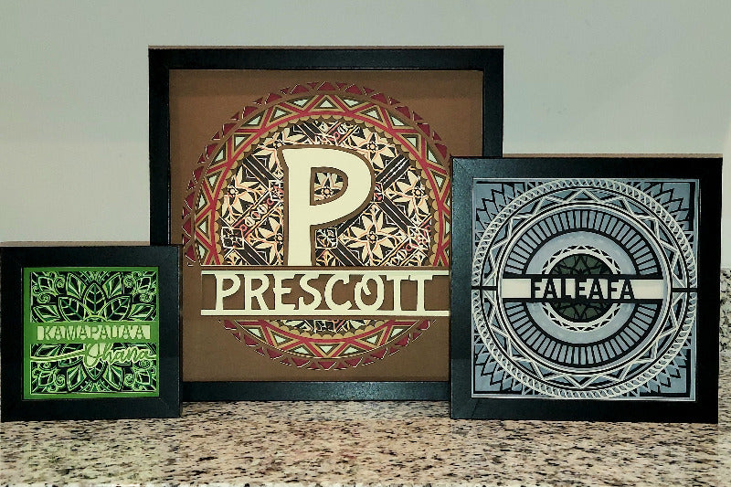 Three framed decorative prints with unique letter designs on a neutral background
