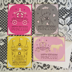 Four 'Happy Birthday Princess!' cards with different designs on a textured surface.