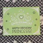 Green birthday card with a princess tiara design and 'Happy Birthday Princess!' text on a textured surface.