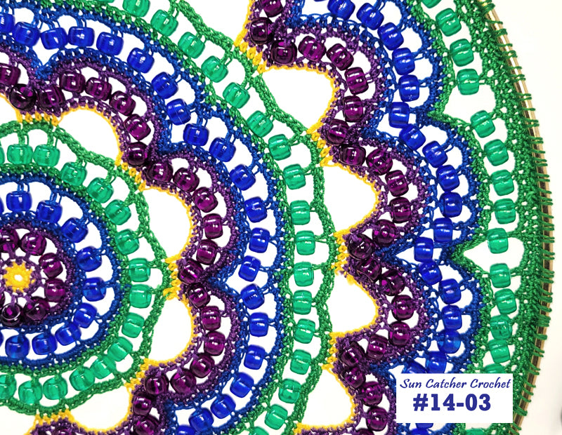 Colorful beaded sun catcher with intricate patterns on a white background