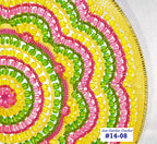 Colorful beaded circular design with pink, green, and yellow colors on a white background.