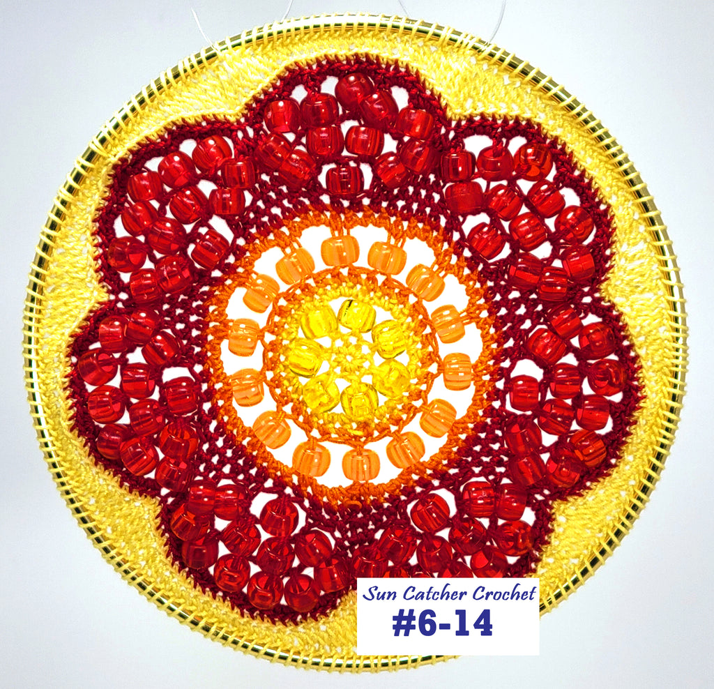 Circular sun catcher crochet project with red, orange, and yellow colors on a white background.