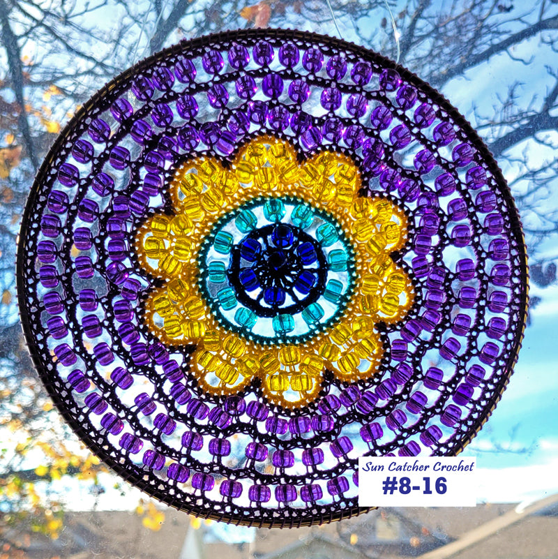 Decorative sun catcher with a floral design and purple border, featuring the brand 'Sun Catcher Crochet'.