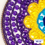 Close-up of a crocheted item with purple beads and colorful yarn, featuring 'Sun Catcher Crochet' branding.