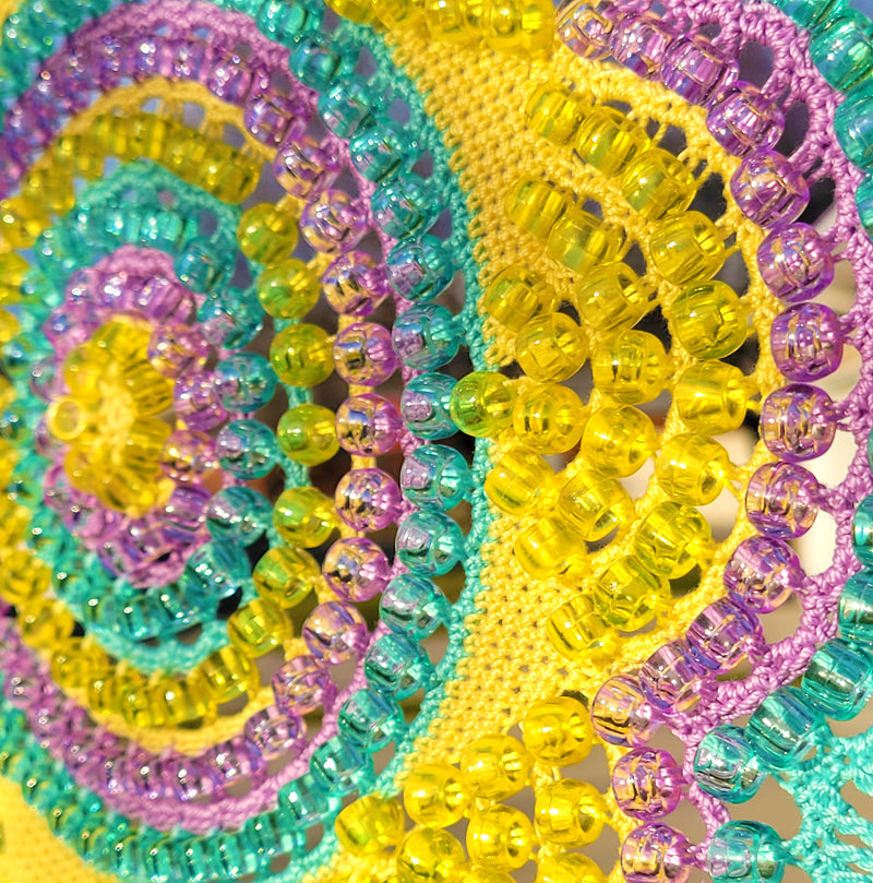 Close-up of colorful beaded bracelets with a peace symbol design.