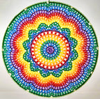 Colorful beaded mandala with a rainbow pattern on a white background