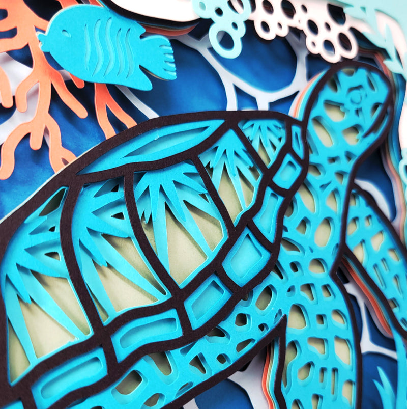 Colorful cut-out sea-themed decorations including a turtle, fish, and coral.