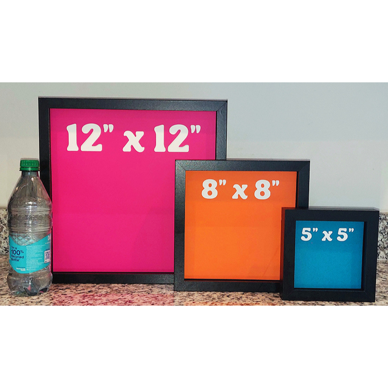 Three picture frames of different sizes with their dimensions displayed, next to a water bottle for scale.