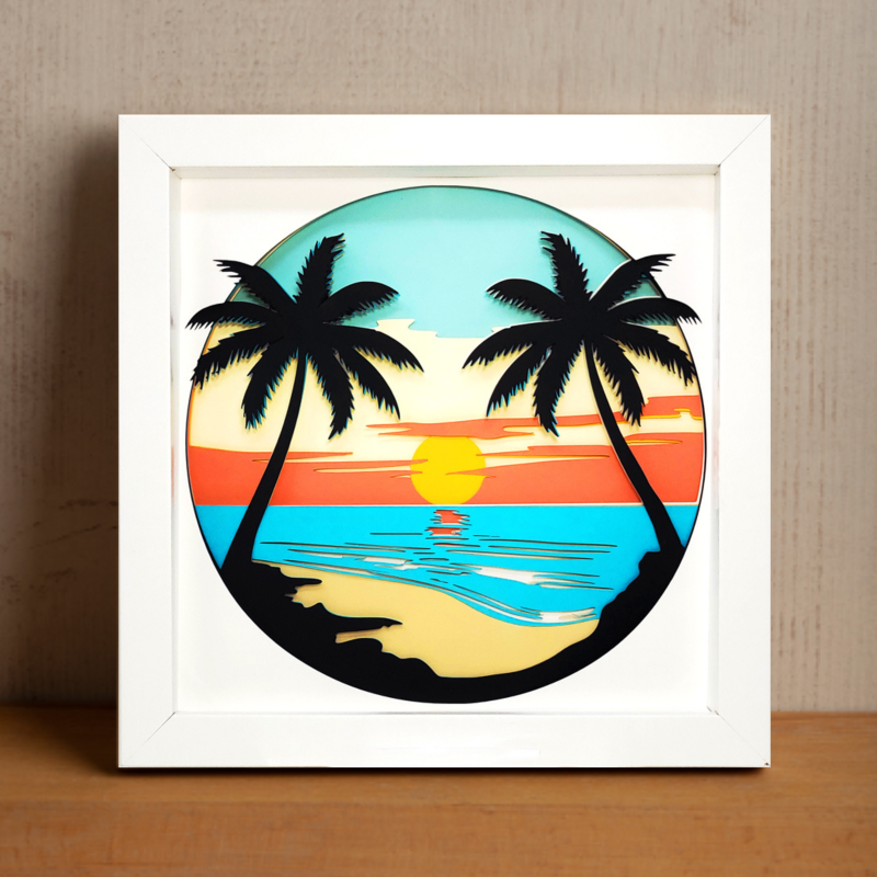 Framed artwork of a tropical sunset with palm trees on a wooden surface.