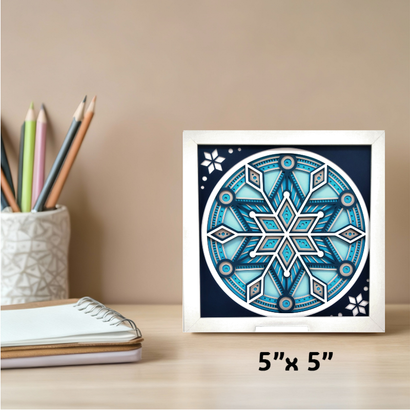 Framed blue geometric design on a desk with stationery items