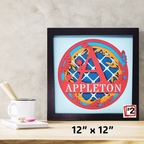 Decorative wall art with 'APPLETON' and a colorful design on a light blue background, framed in black.