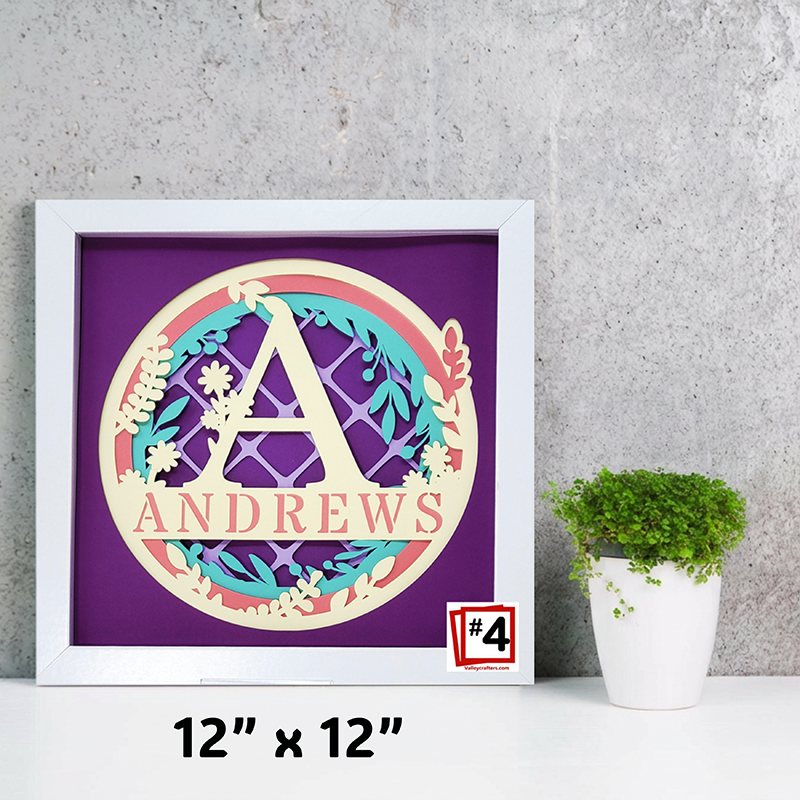 Decorative wall art with a colorful letter 'A' and name 'ANDREWS' on a purple background, framed in white.