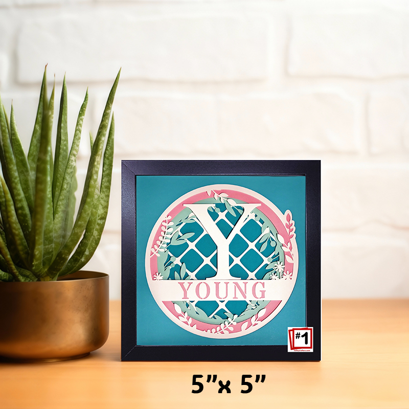 Decorative framed print with personalized names on a surface.