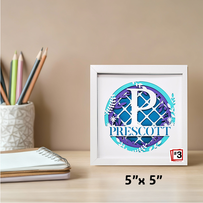 Framed artwork with 'Prescott' on a desk with stationery items.