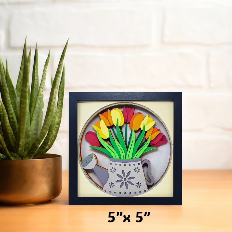 Framed artwork of colorful tulips on a wooden surface with a plant in the background