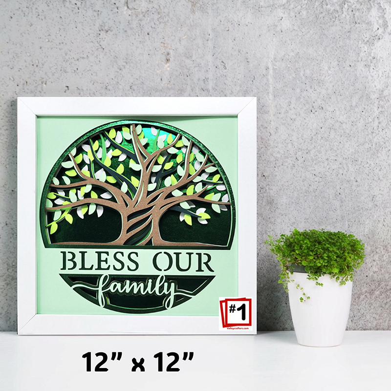Decorative wall art with a tree design and 'Bless Our Family' text on a light green background, framed in white.