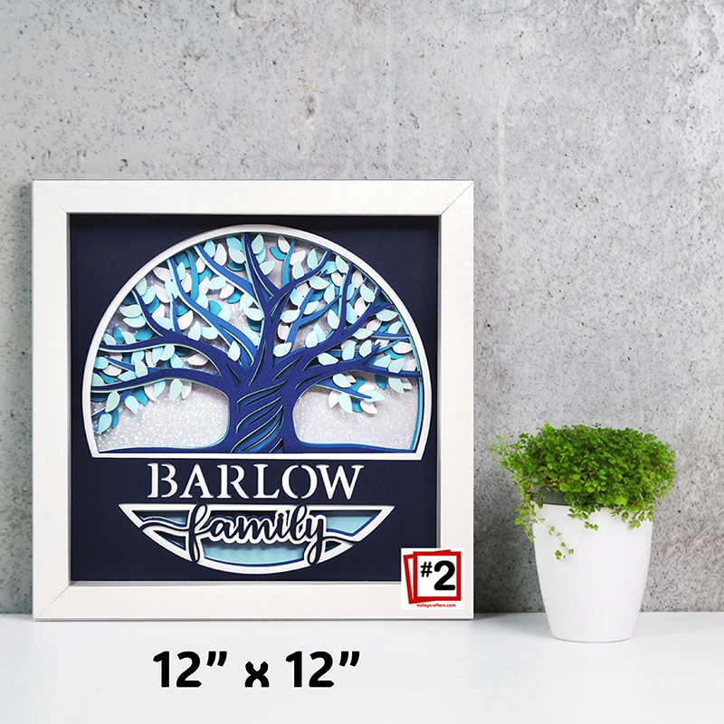 Framed artwork with a blue tree design and 'Barlow Family' text on a gray wall.