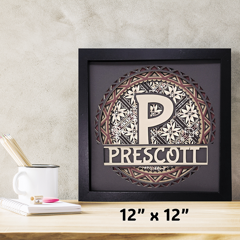 Decorative wall art with a monogram and 'Prescott' text on a wooden surface.