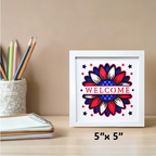 Framed artwork with a red, white, and blue design on a desk with stationery items.