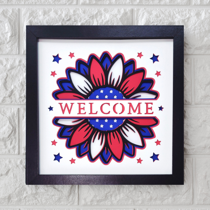 Framed artwork with a floral design and 'WELCOME' text on a white background