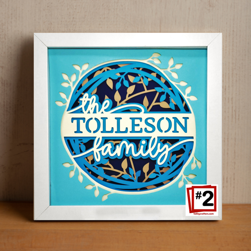 Framed artwork with 'the TOLLESON family' text on a blue background