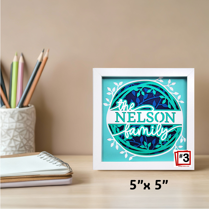 Framed artwork with 'Nelson family' text on a desk with stationery items.