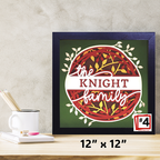 Framed artwork with 'the KNIGHT family' text on a green background, placed on a wooden surface.