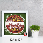 Framed artwork with 'The Knight Family' design on a gray wall with a plant.