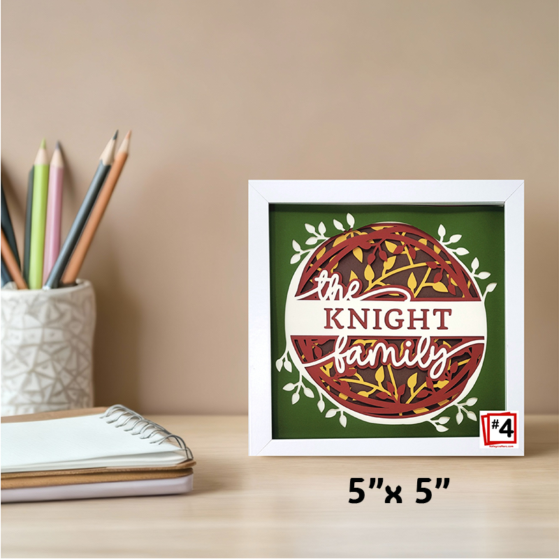 Framed artwork with 'the Knight family' text on a desk with stationery items.