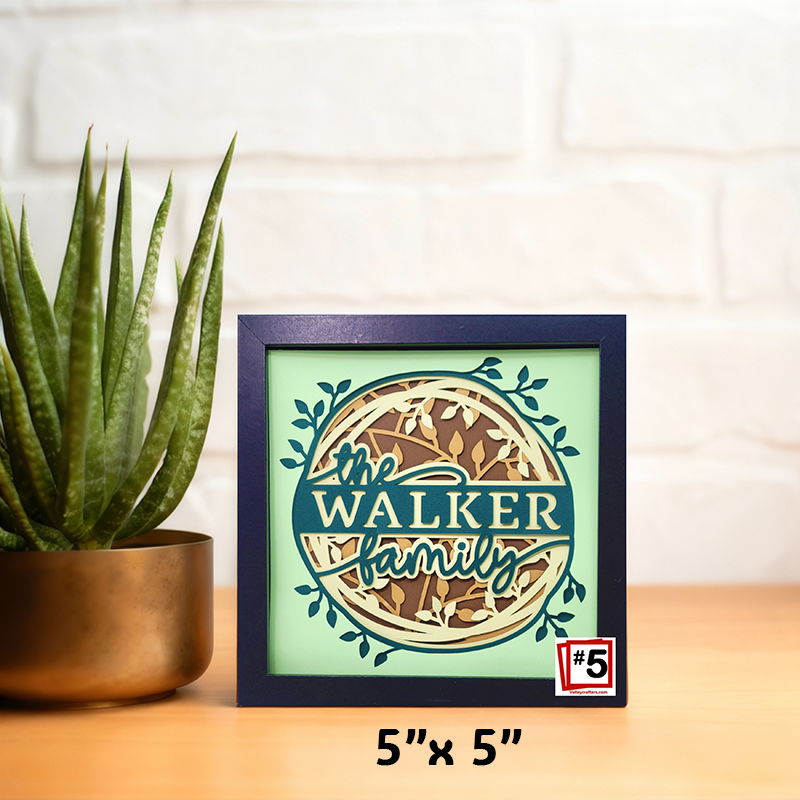 Framed decorative sign with 'the Walker Family' text, potted plant on the side