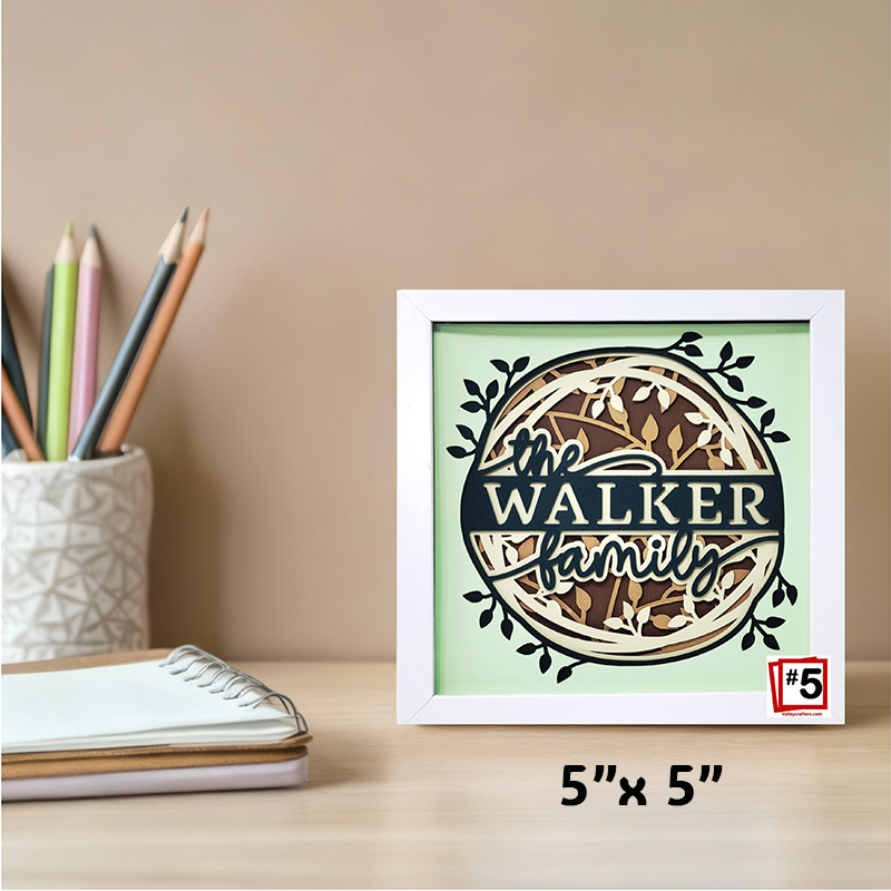 Framed artwork with 'The Walker family' text on a desk with stationery items.